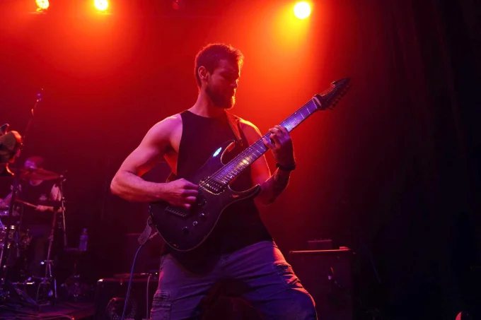 Joe Macedo performing live on stage with his band